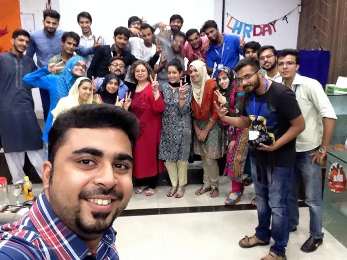 Selfie with a group making victory signs at an event