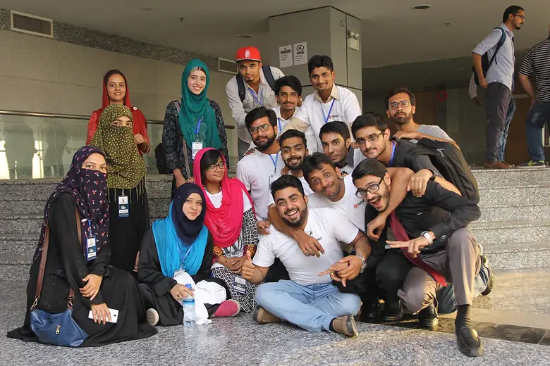 Outdoor group photo of event attendees wearing lanyards