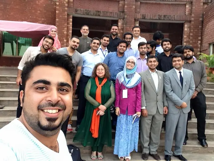 Selfie with a group on the steps of a brick building