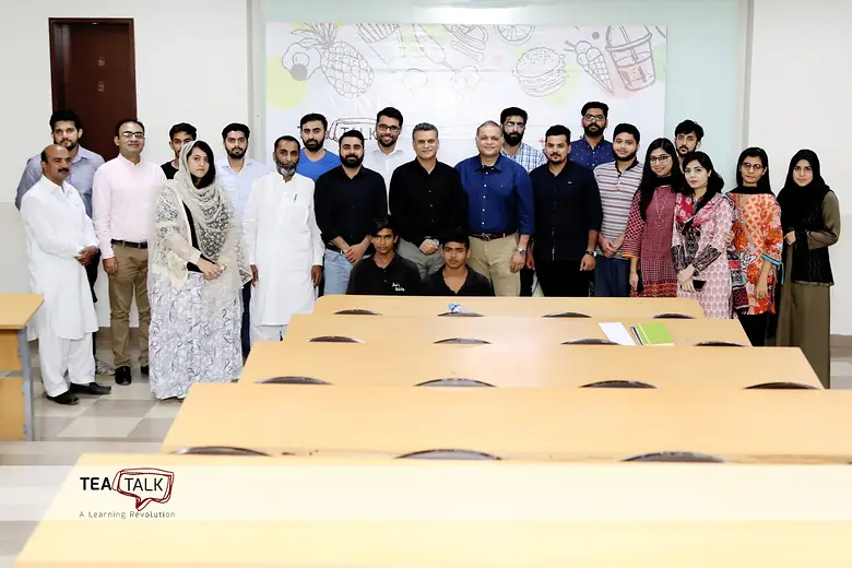 Group photo in a classroom at a Tea Talk session