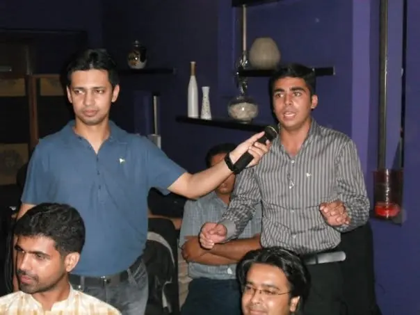 Audience member speaking into a microphone at an early event